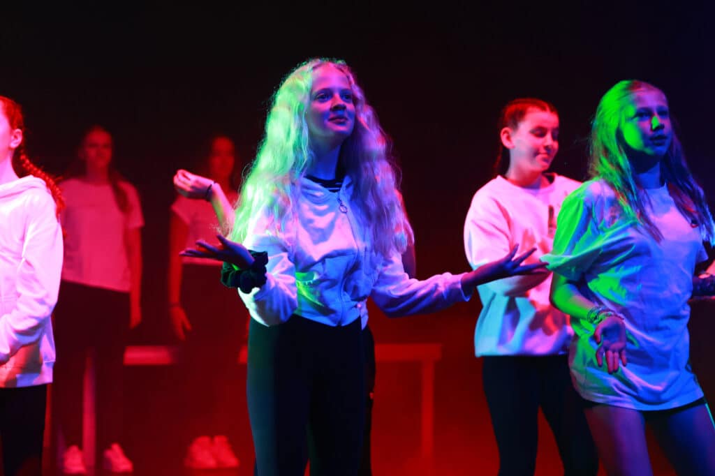 Children at a performing arts class with an EDUCATION caption